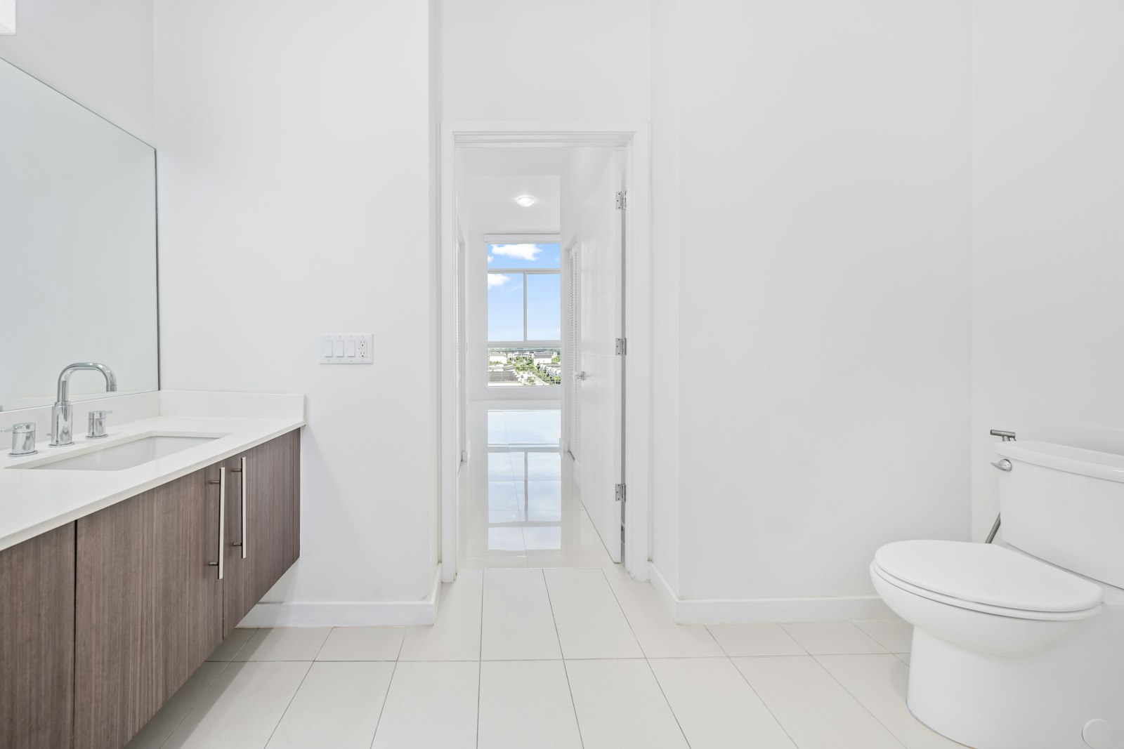 Modern white bathroom with a clean toilet ready for bidet use